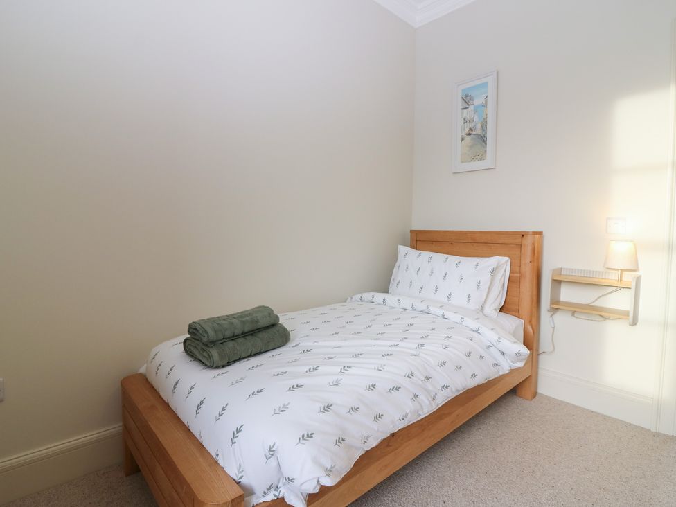 A bedroom with a bed and towels at Balmashanner Farmhouse in Forfar