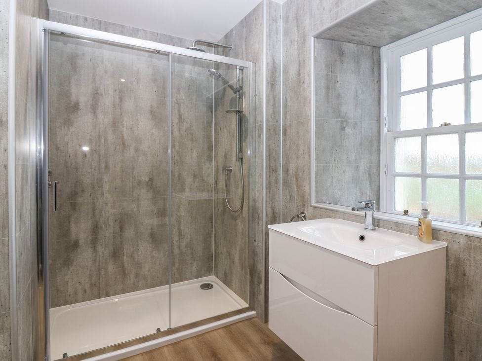 A bathroom with a shower and a sink at Balmashanner Farmhouse in Forfar