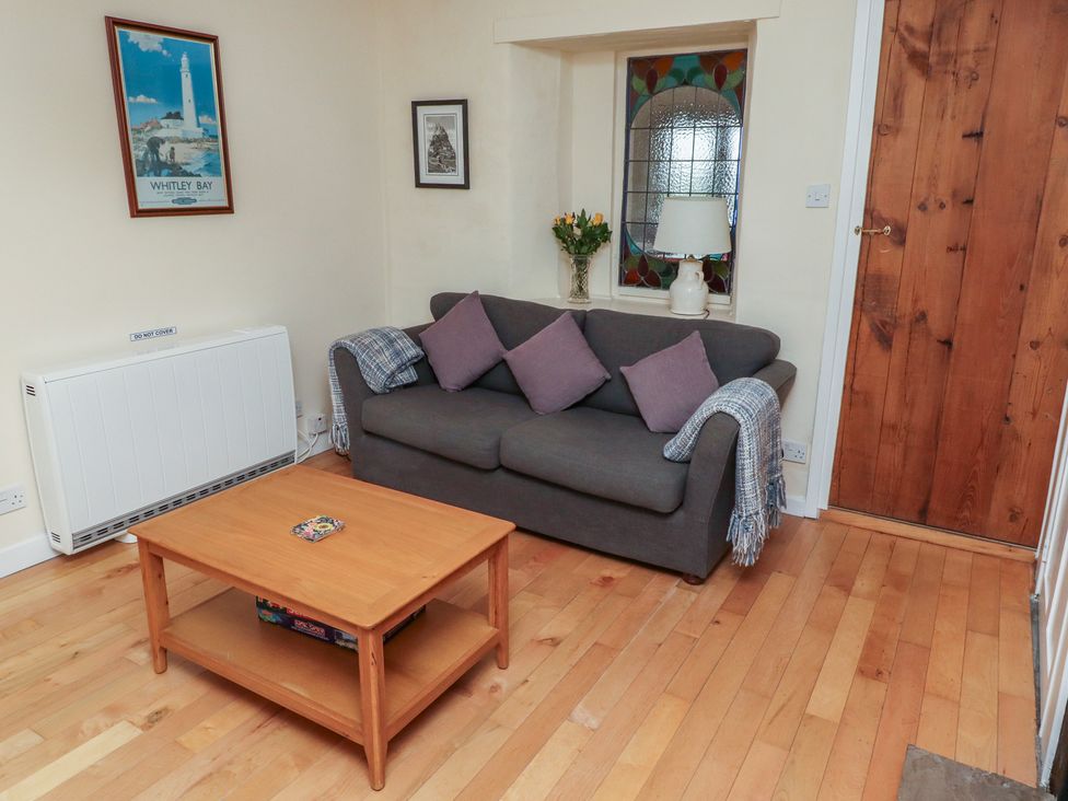 A living room with a sofa and coffee table at Sunny Brae in Alnwick