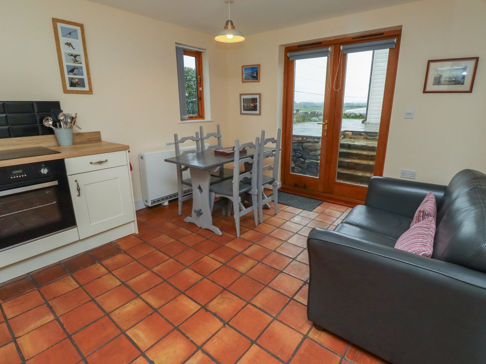 A kitchen with dining area and sofa at Sunny Brae in Alnwick