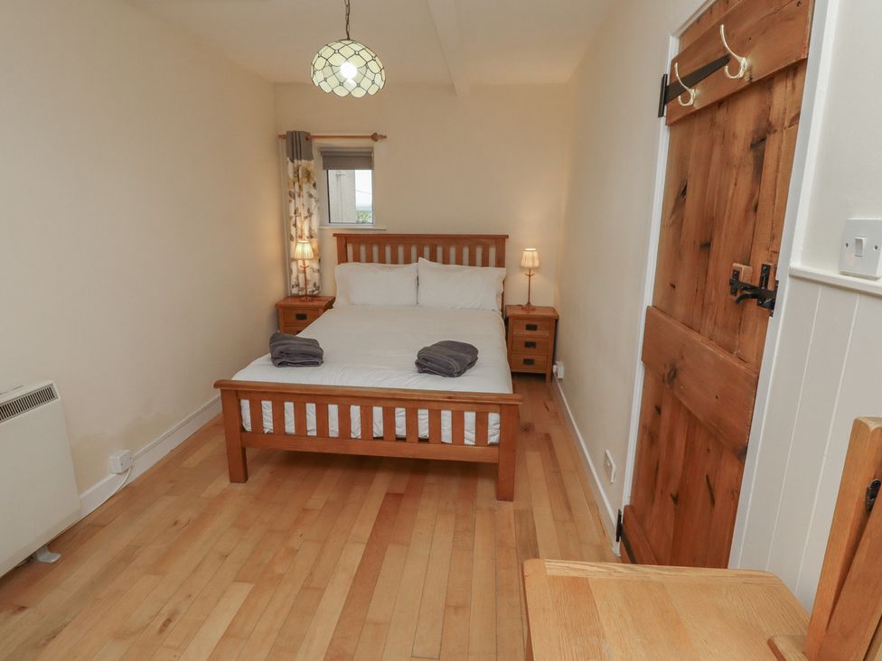 A bedroom with a bed and nightstand at Sunny Brae in Alnwick