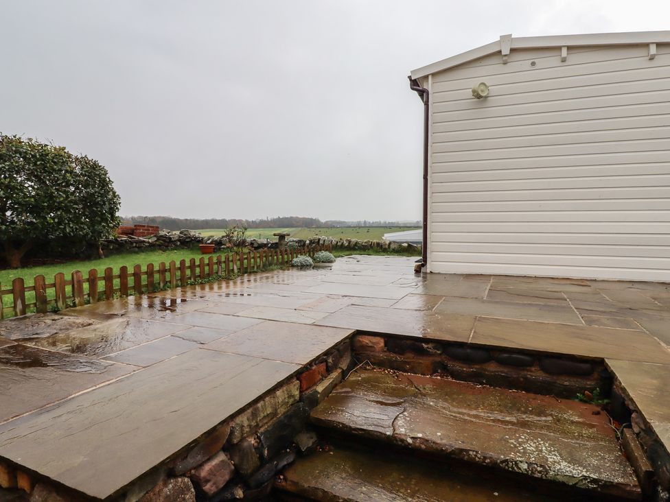 An outdoor area with a stone patio and steps at Sunny Brae in Alnwick