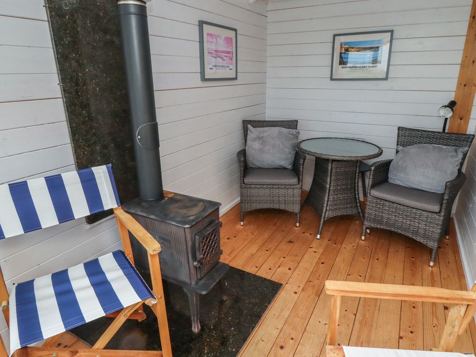 A snug with chairs and a wood stove at Sunny Brae in Alnwick