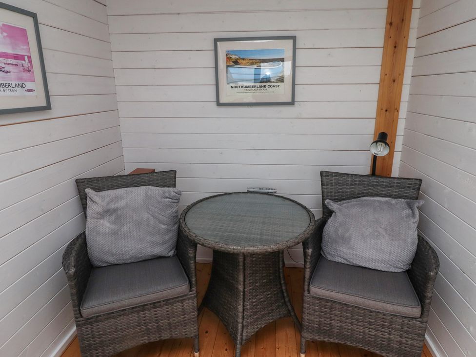 A snug area with two chairs and a table at Sunny Brae in Alnwick
