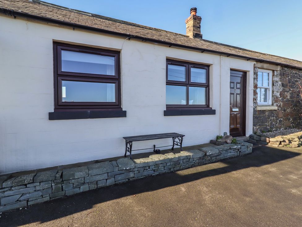 An exterior view of a cottage with windows and a door at 2 Sunny Brae Embleton