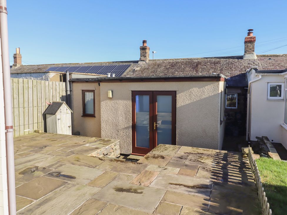 An outdoor view of a house with a patio area at 2 Sunny Brae in Embleton