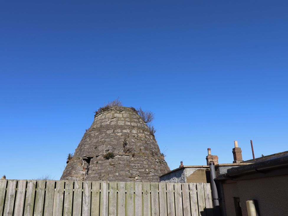 A stone structure and a fence in the background at 2 Sunny Brae in Embleton