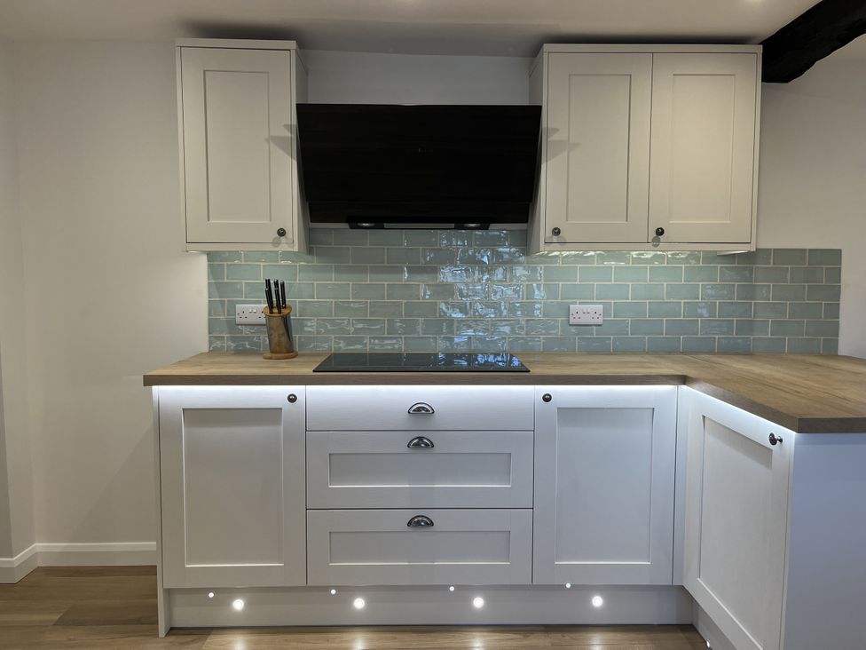 A kitchen with cabinets and countertop at Manor Cottage in Ilminster
