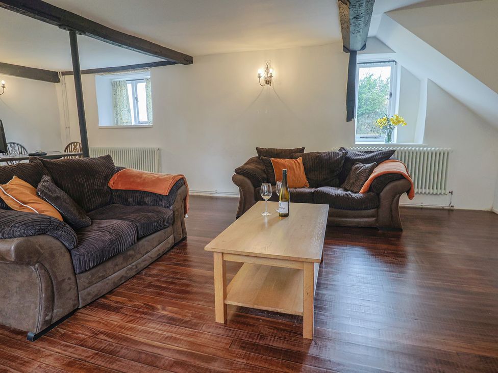 A living room with sofas and a coffee table at Manor Cottage in Kingstone near Ilminster