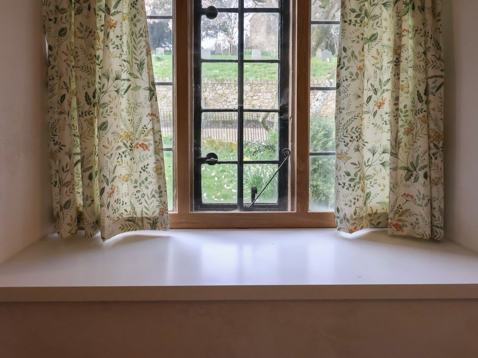 A living room window with curtains and a windowsill at Manor Cottage Kingstone near Ilminster