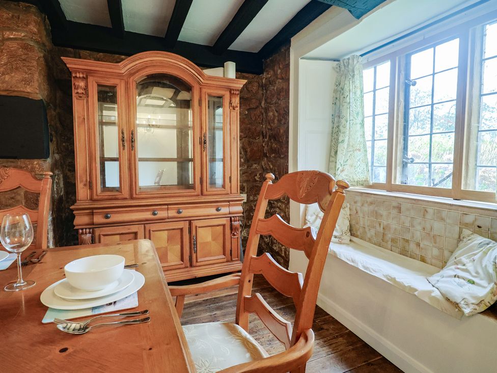 A dining room with a table and chairs at Manor Cottage in Kingstone near Ilminster