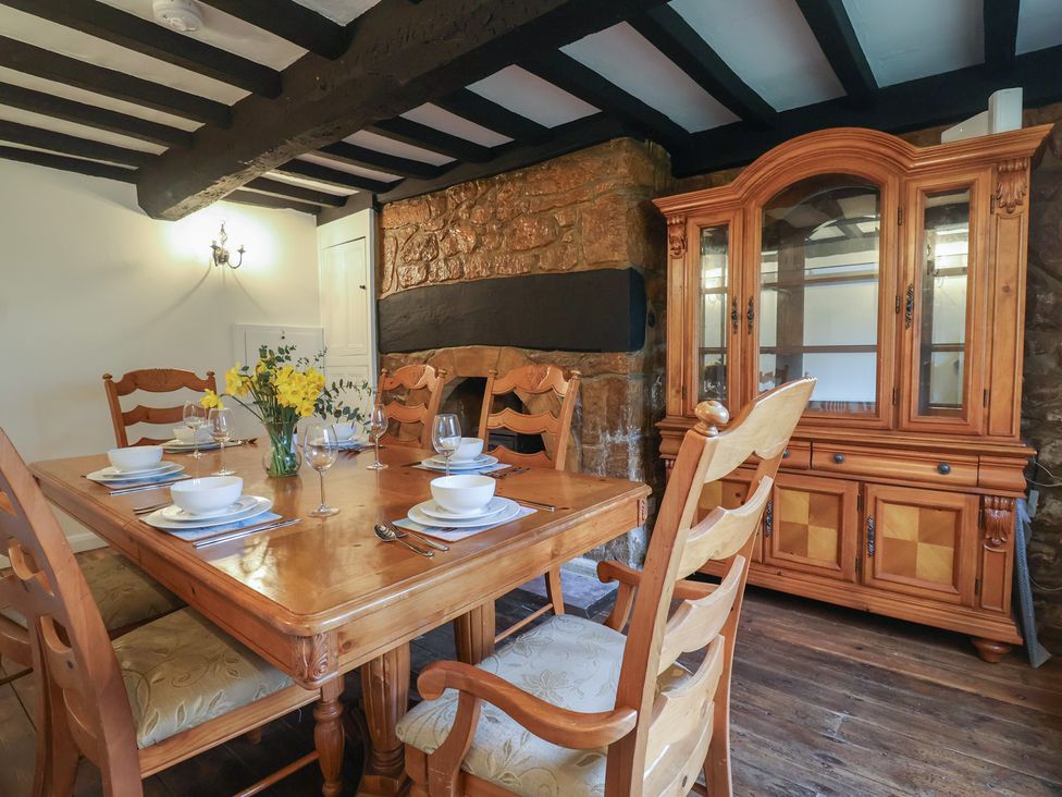 A dining room with a wooden table and chairs at Manor Cottage in Kingstone near Ilminster