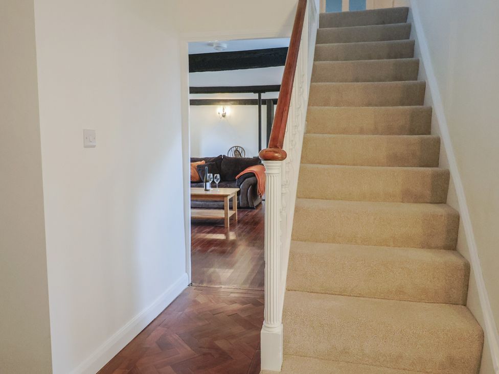 A staircase leading to an upper floor at Manor Cottage in Kingstone near Ilminster