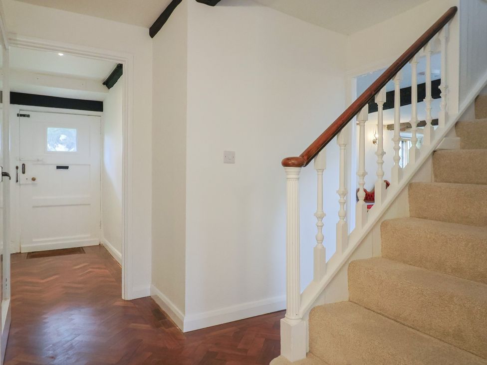 A hallway with a staircase at Manor Cottage in Kingstone near Ilminster
