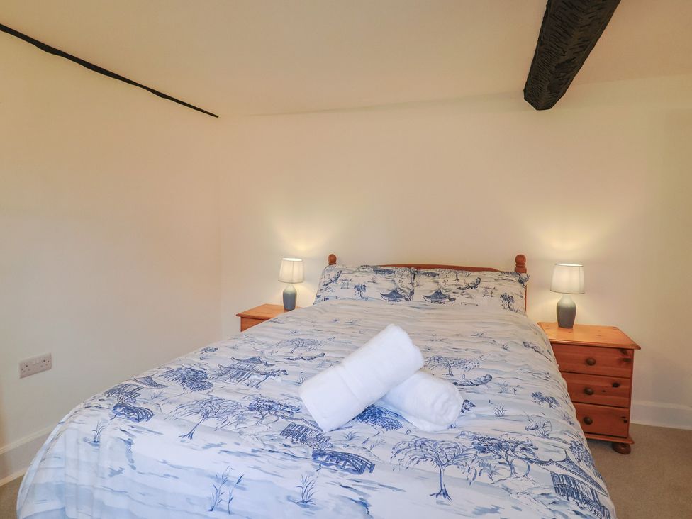 A bedroom with a bed and bedside tables at Manor Cottage in Kingstone near Ilminster