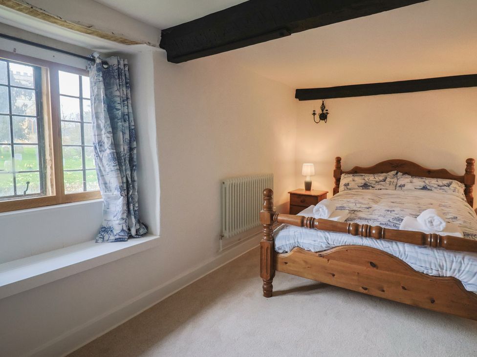 A bedroom with a bed and window at Manor Cottage in Kingstone near Ilminster