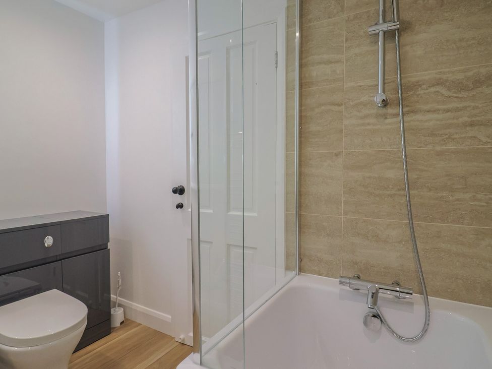 A bathroom with a shower and bathtub at Manor Cottage Kingstone near Ilminster