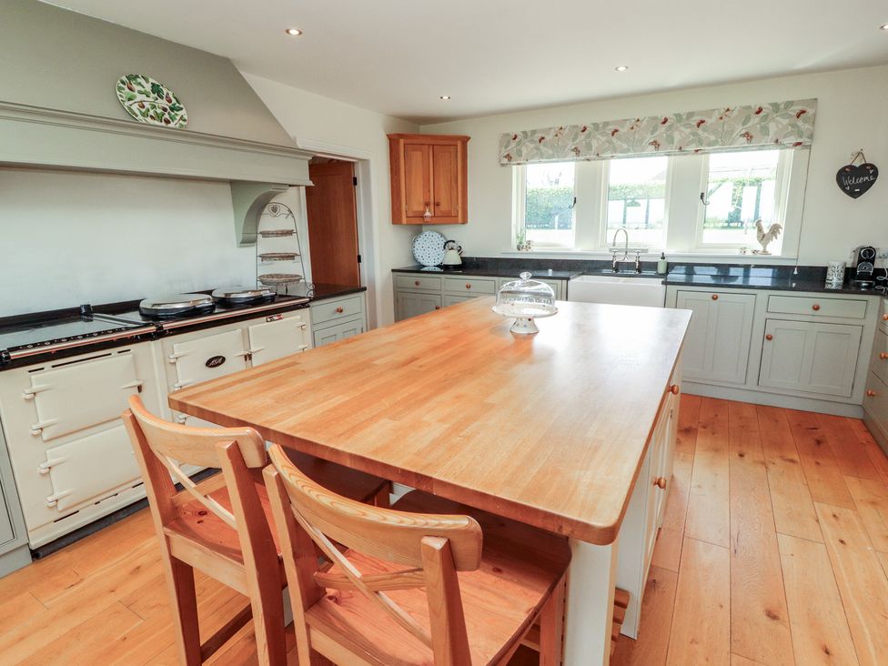 A kitchen with a stove and kitchen island at Thimble Hill near Armathwaite