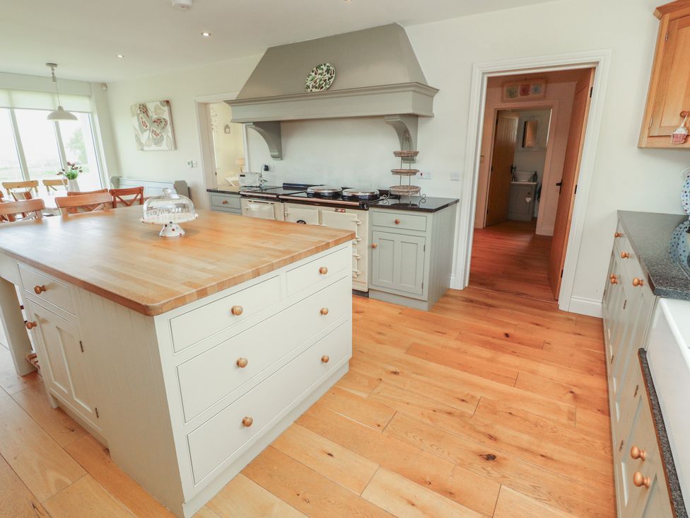 A kitchen with an island and oven at Thimble Hill near Armathwaite