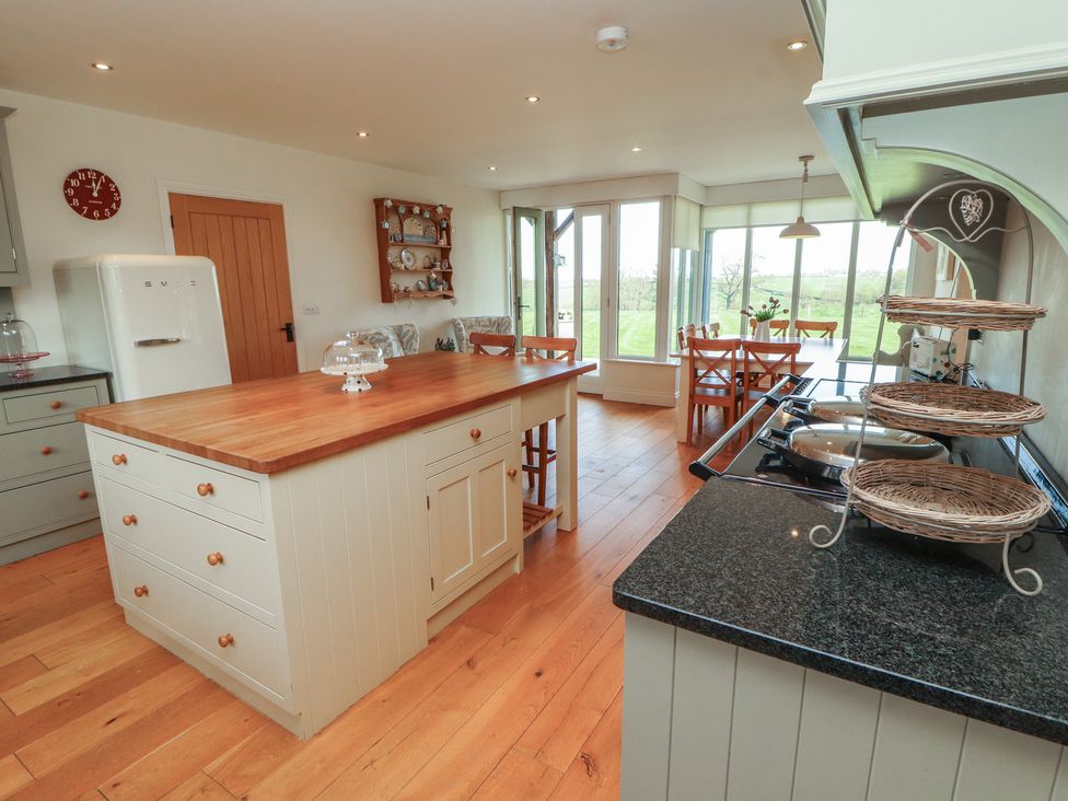 A kitchen with an island and dining table at Thimble Hill Near Armathwaite