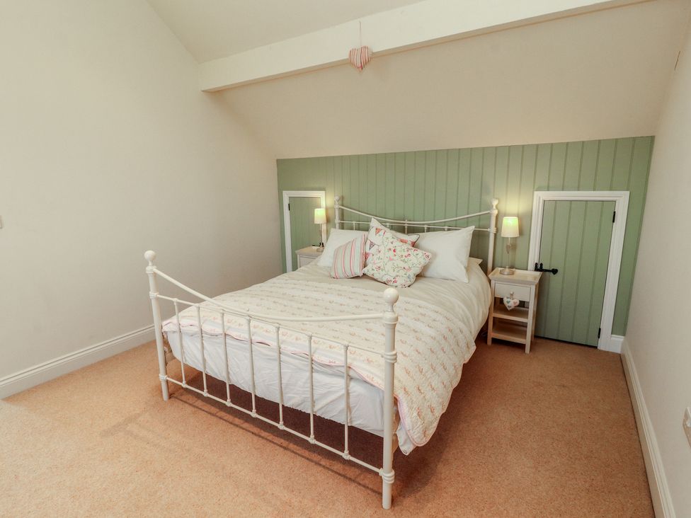A bedroom with a bed and bedside table at Thimble Hill Near Armathwaite