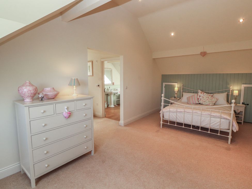 A bedroom with a bed and dresser at Thimble Hill Near Armathwaite