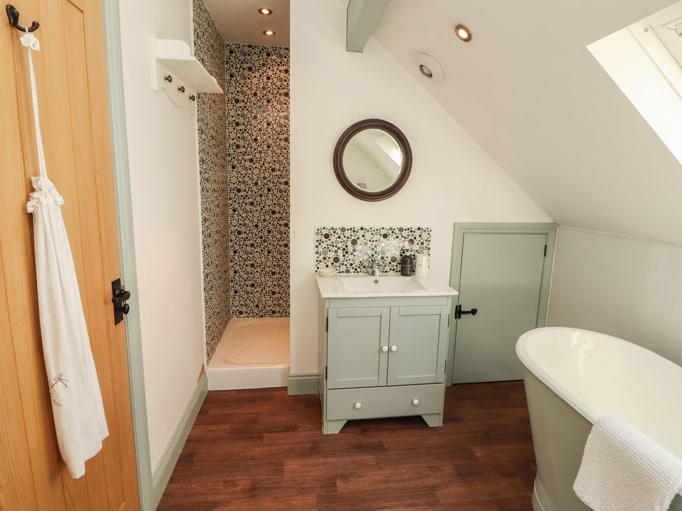 A bathroom with a bath tub, sink, and shower at Thimble Hill near Armathwaite