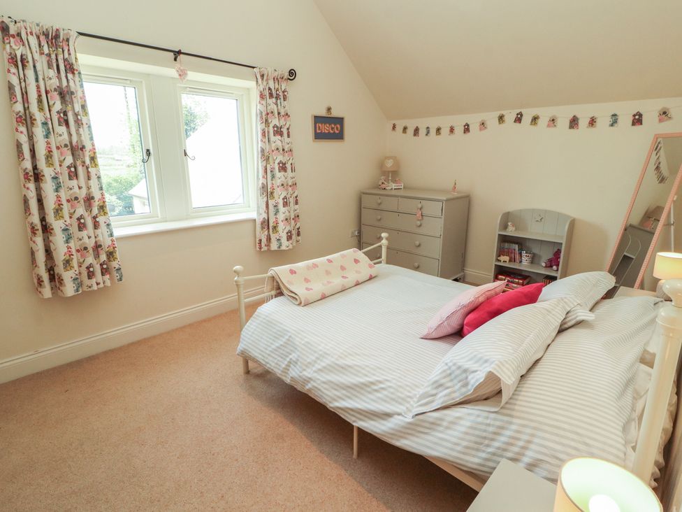 A bedroom with a bed and a dresser at Thimble Hill near Armathwaite
