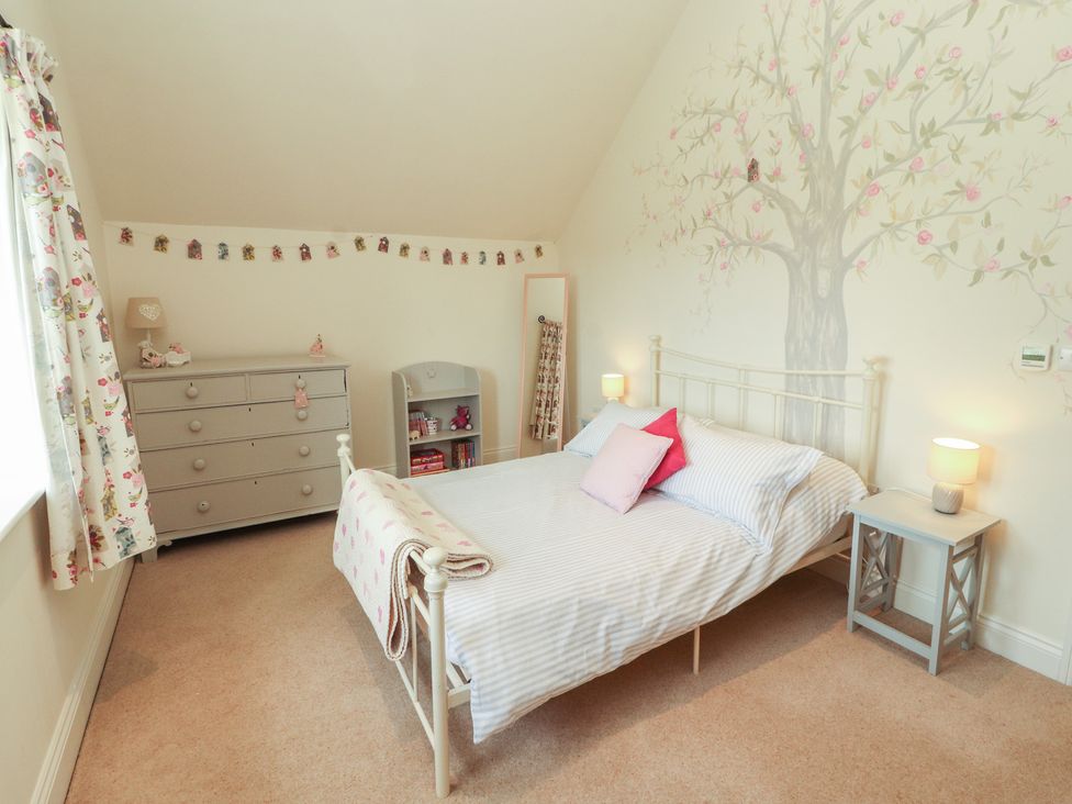 A bedroom with a bed and dresser at Thimble Hill near Armathwaite