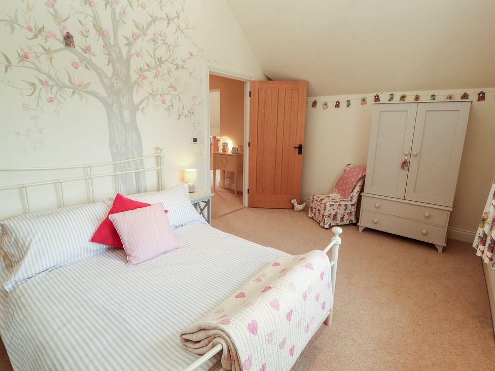 A bedroom with a bed and wardrobe at Thimble Hill Near Armathwaite