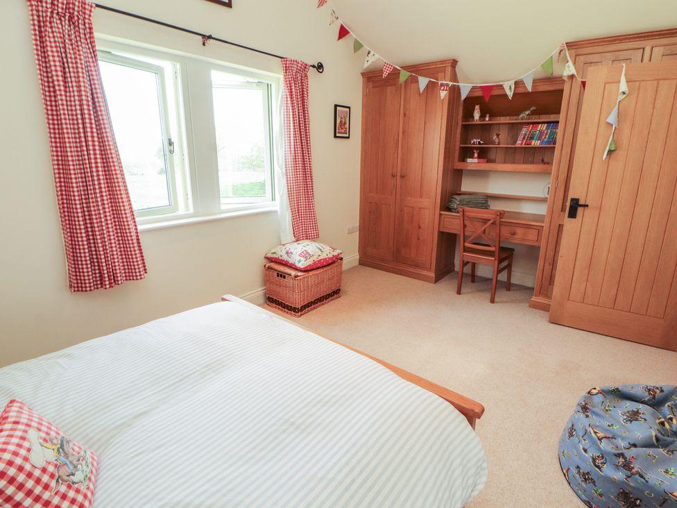 A bedroom with a bed and desk at Thimble Hill Near Armathwaite
