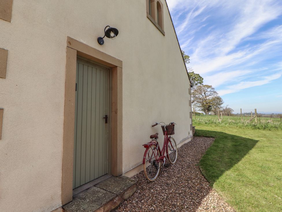 A door and bicycle by the wall at Thimble Hill near Armathwaite