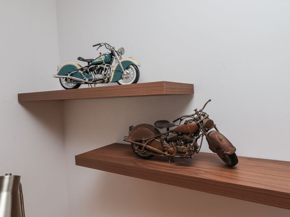 Two motorcycle models displayed on a wooden shelf at 1 Sunnybrae Alnwick