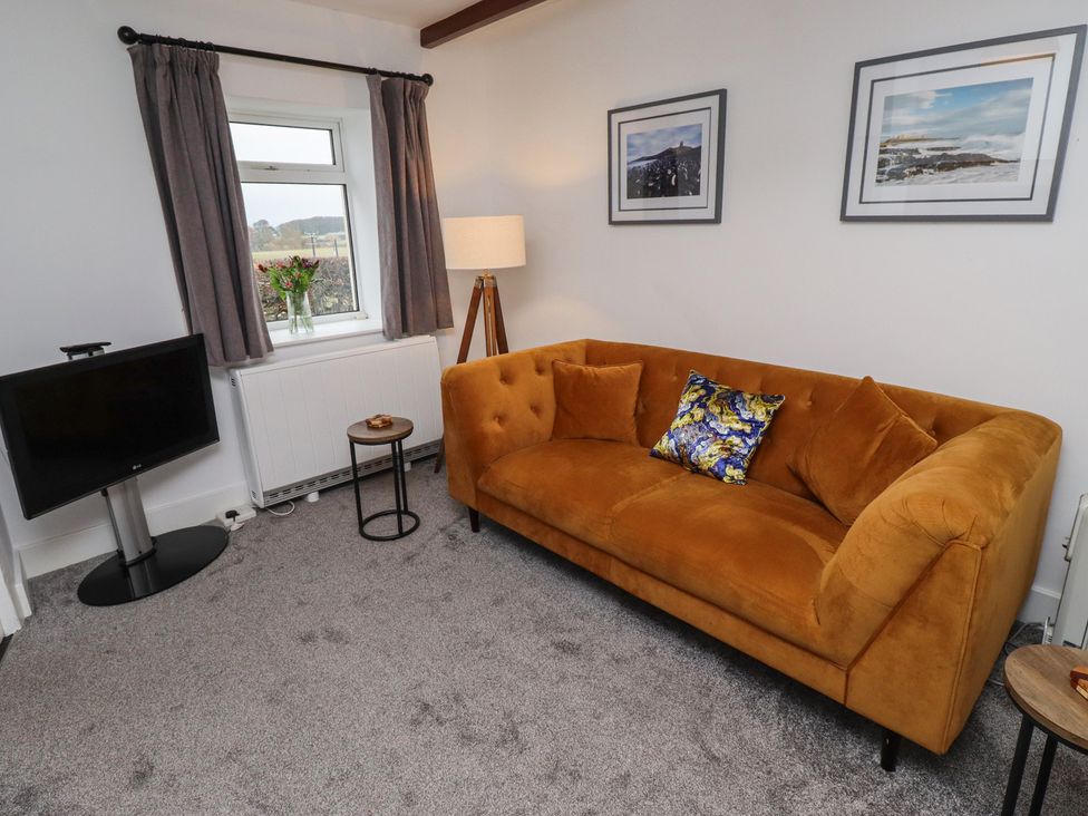 A living room with a TV, sofa and lamp at 1 Sunnybrae Alnwick