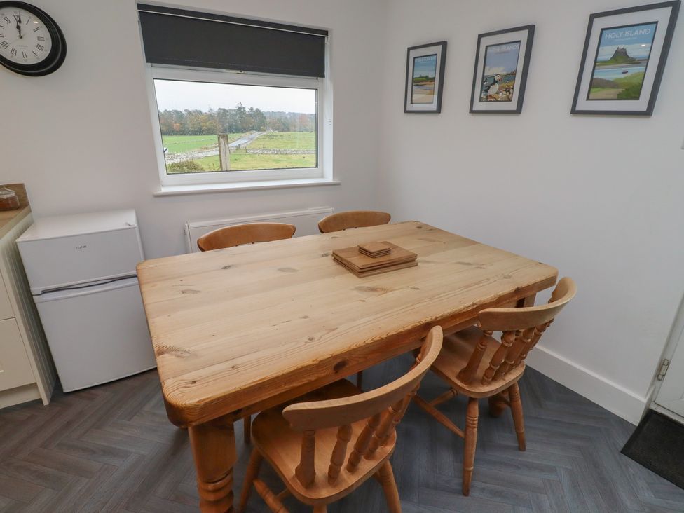 A dining room with a wooden table and chairs at 1 Sunnybrae in Alnwick