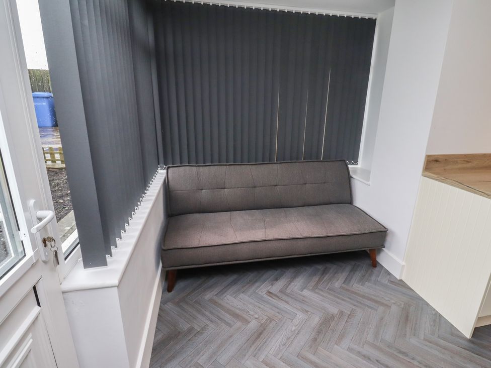 A snug with a sofa and window blinds at 1 Sunnybrae Alnwick