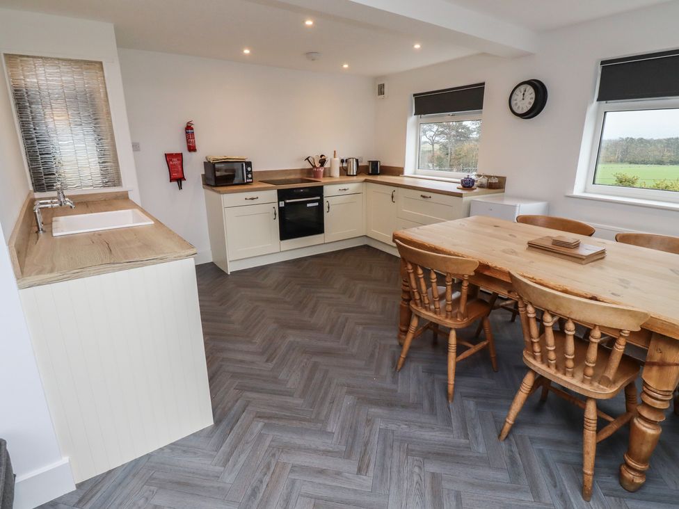 A kitchen with a table and chairs at 1 Sunnybrae in Alnwick