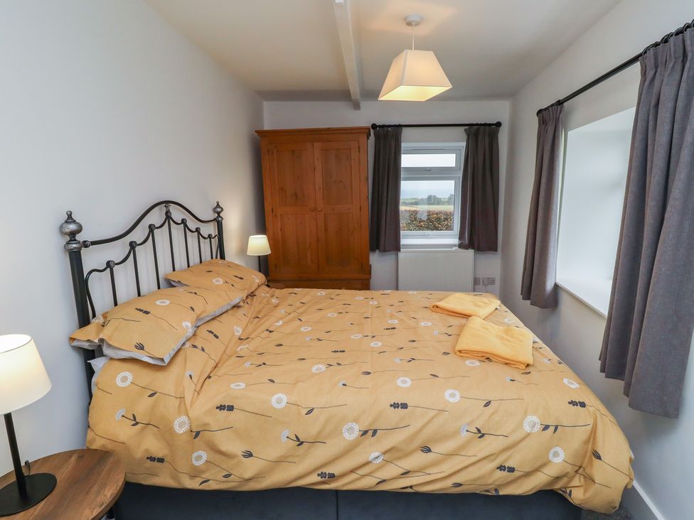 A bedroom with a bed, wardrobe, and window at 1 Sunnybrae in Alnwick