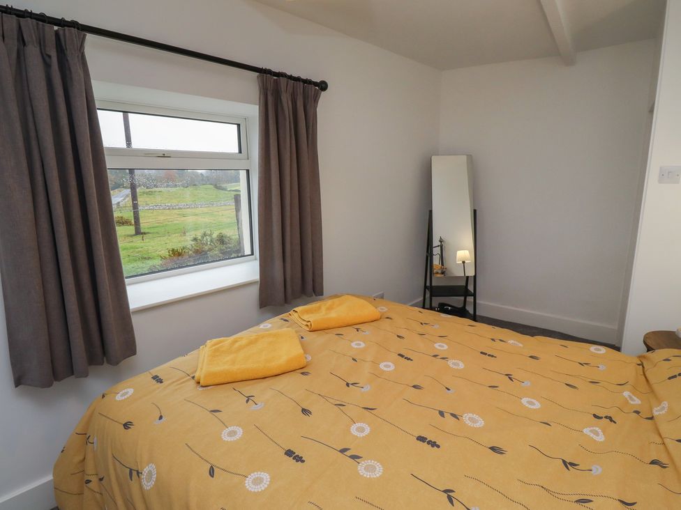 A bedroom with a bed and a window at 1 Sunnybrae, Alnwick