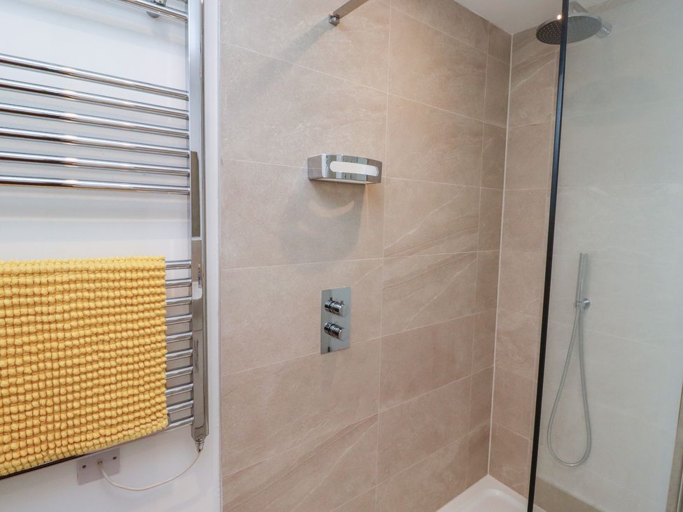 A shower with water controls and a towel rail at 1 Sunnybrae in Alnwick