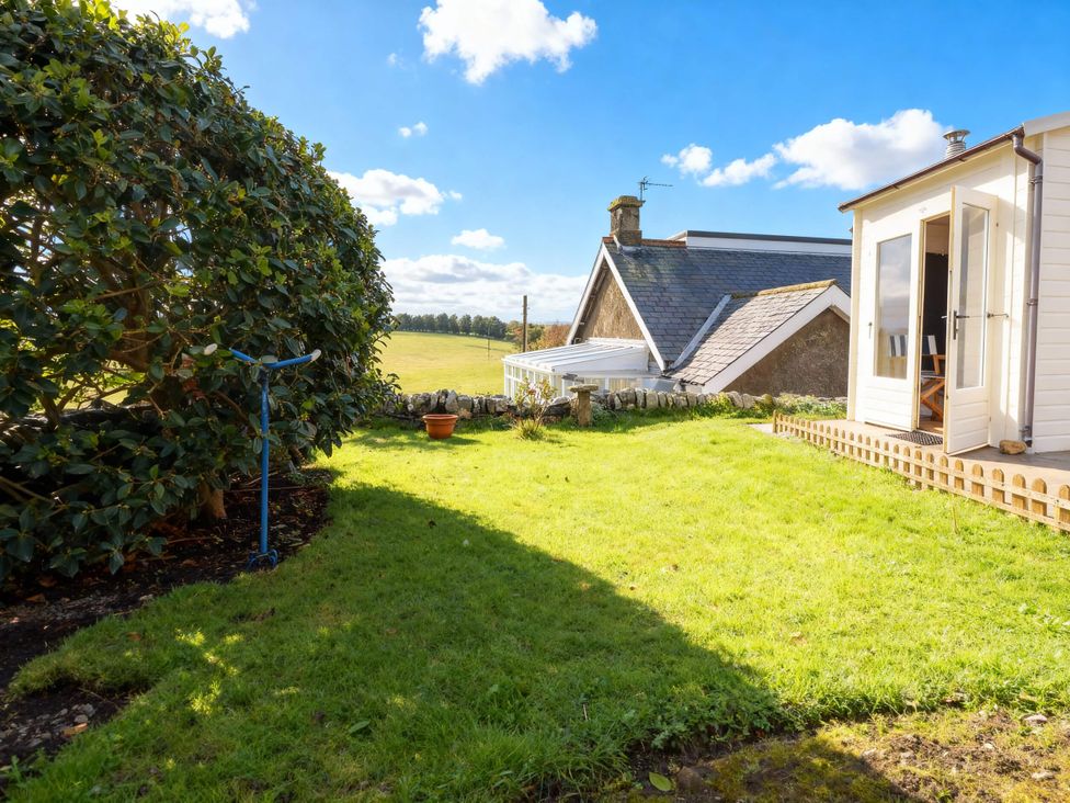 A garden with grass and a plant pot at 1 Sunny Brae in Embleton