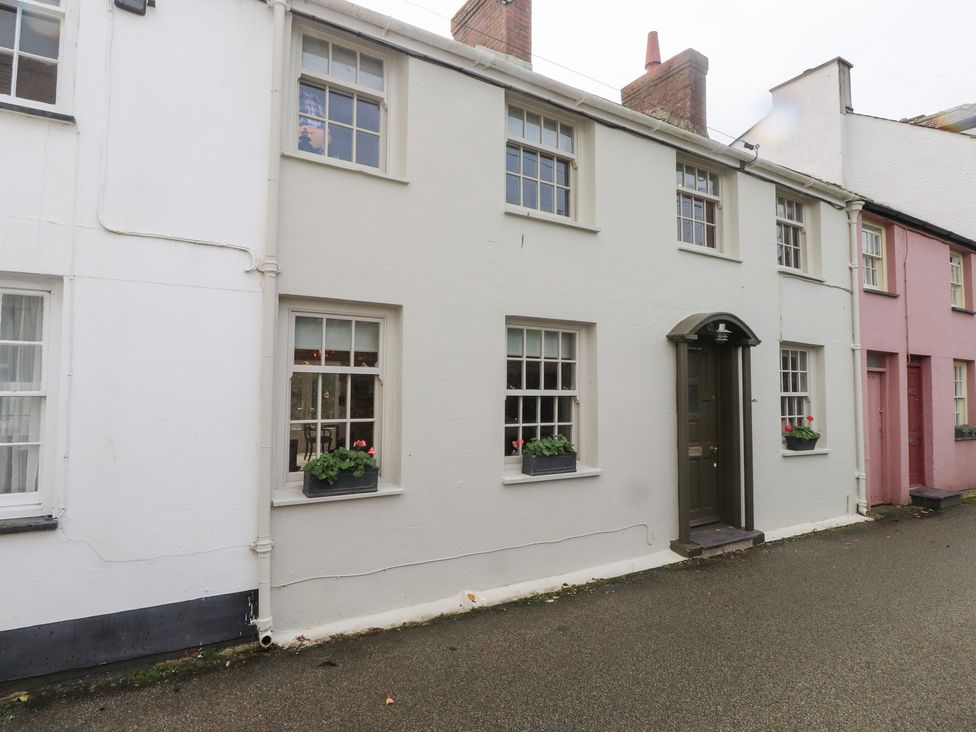 A house with a door and windows on a street at The Music Box in Beaumaris