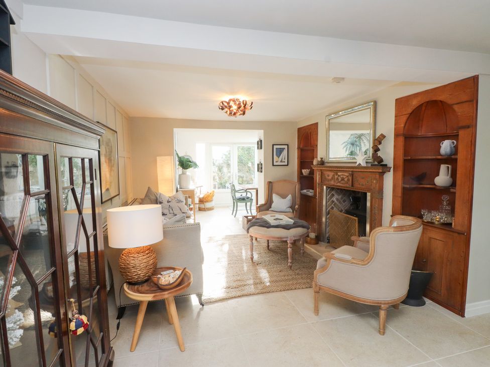 A living room with a sofa and fireplace at The Music Box Beaumaris