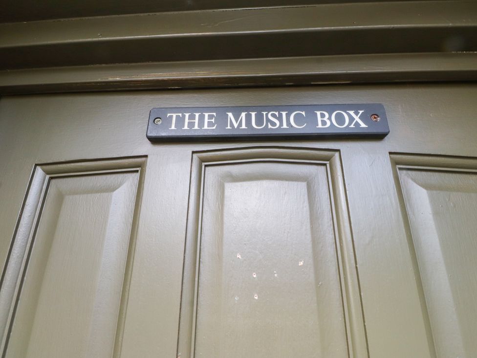 A door with a sign reading The Music Box at The Music Box in Beaumaris