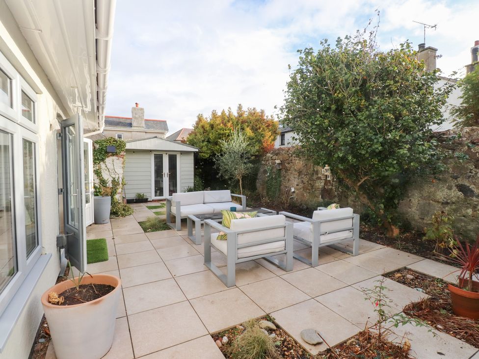 An outdoor seating area with tiles and plants at The Music Box in Beaumaris