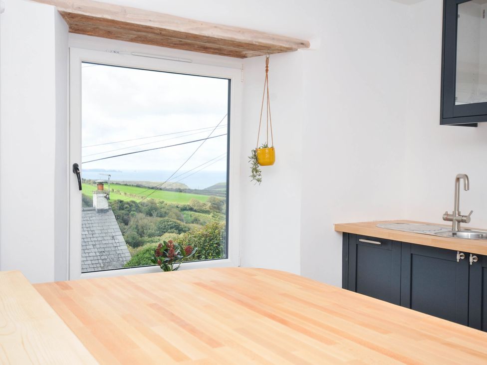 A kitchen with a window and a countertop at Boscabrea near Tintagel