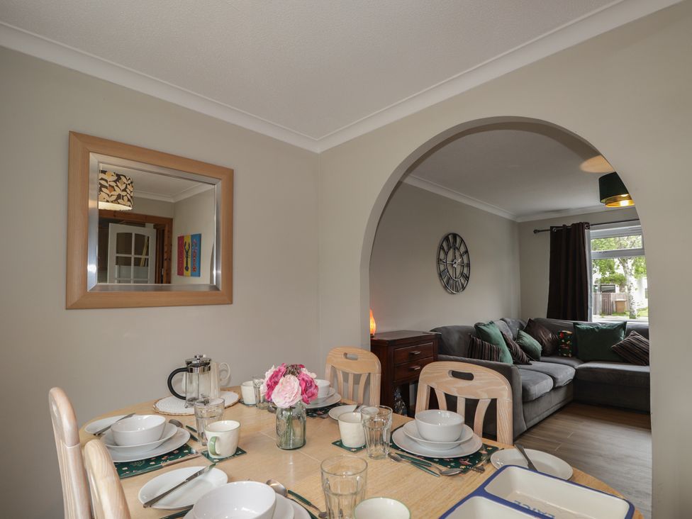 A dining room with a table set for meals at Clans Crescent in Nairn