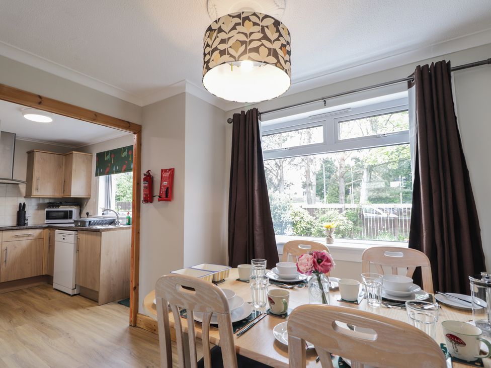 A dining room with a table set for meals at Clans Crescent Nairn