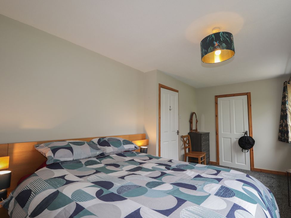 A bedroom with a bed and furniture at Clans Crescent in Nairn