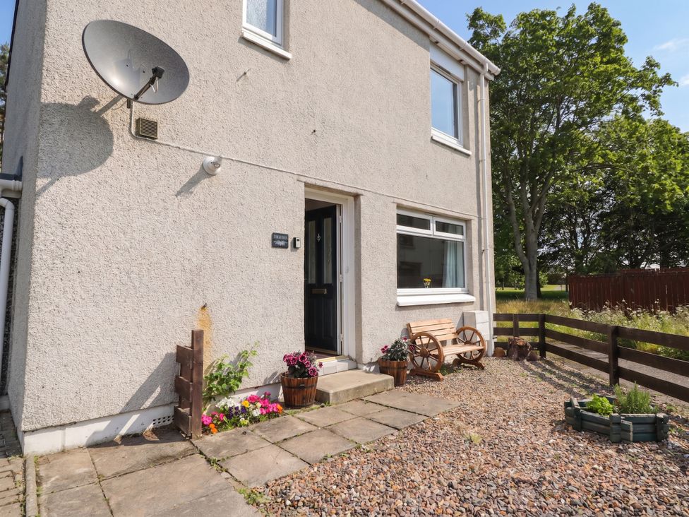 A front entrance with flowers and gravel pathway at Taigh Ban in Nairn